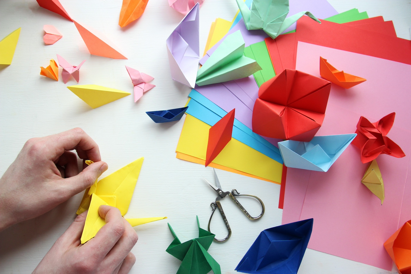 Origami-and-hands-folding-paper